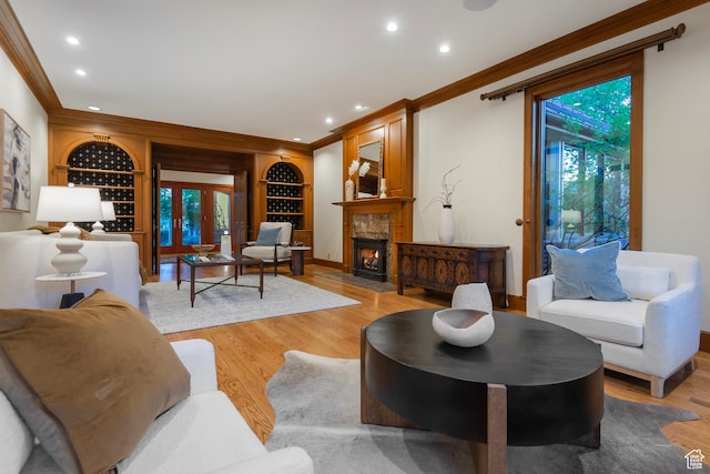 1358 E Tomahawk Dr N, Salt Lake City, UT 84103 - living room with crown molding, built in shelves, light wood finished floors, recessed lighting, and a high end fireplace