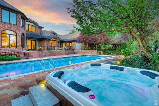1358 E Tomahawk Dr N, Salt Lake City, UT 84103 - swimming pool featuring a hot tub, a patio area, and french doors