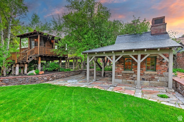 1358 E Tomahawk Dr N, Salt Lake City, UT 84103 - yard at dusk featuring a yard, stairs, and covered porch