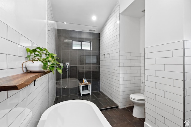 939 S Donner Way Unit 308, Salt Lake City, UT 84108 - full bath featuring tile walls, a freestanding bath, toilet, tile patterned floors, and a tile shower