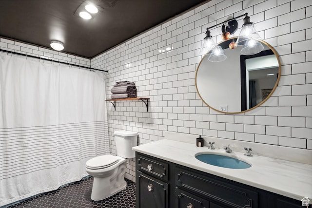 939 S Donner Way Unit 308, Salt Lake City, UT 84108 - full bathroom featuring tile walls, vanity, toilet, tile patterned floors, and curtained shower