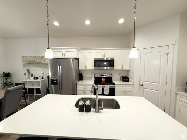 4323 W Burwell Ln, Herriman, UT 84096 - kitchen with appliances with stainless steel finishes, a sink, light countertops, pendant lighting, and recessed lighting