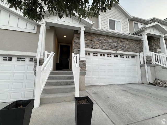 4323 W Burwell Ln, Herriman, UT 84096 - view of front of house with stone siding, a garage, concrete driveway, and stucco siding