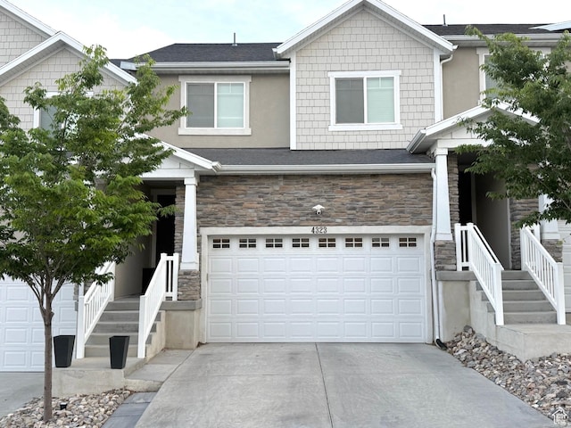 4323 W Burwell Ln, Herriman, UT 84096 - view of front of property featuring stone siding, concrete driveway, a garage, and stucco siding