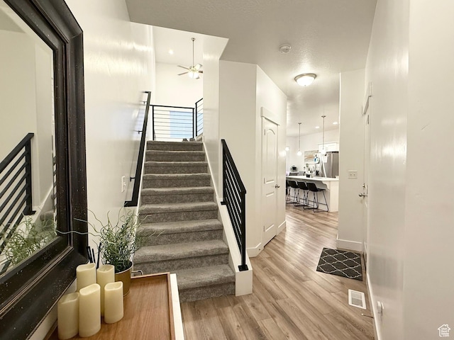 4323 W Burwell Ln, Herriman, UT 84096 - stairs with a ceiling fan, wood finished floors, and baseboards