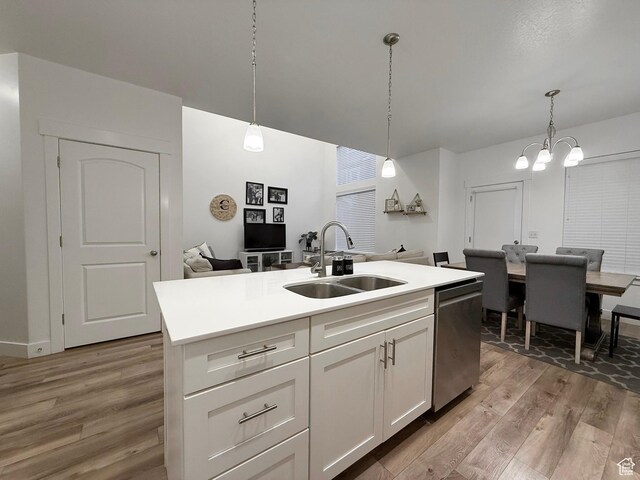 4323 W Burwell Ln, Herriman, UT 84096 - kitchen with a sink, dishwasher, light wood-style floors, white cabinetry, and hanging light fixtures
