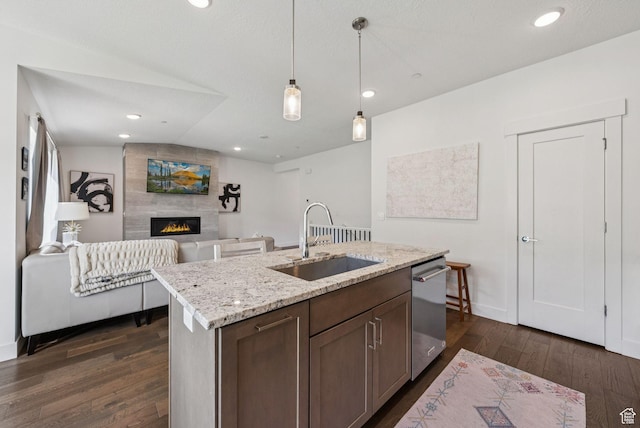 8210 N Toll Creek Ln, Park City, UT 84098 - kitchen featuring a sink, dishwasher, dark wood-style flooring, a tile fireplace, and decorative light fixtures