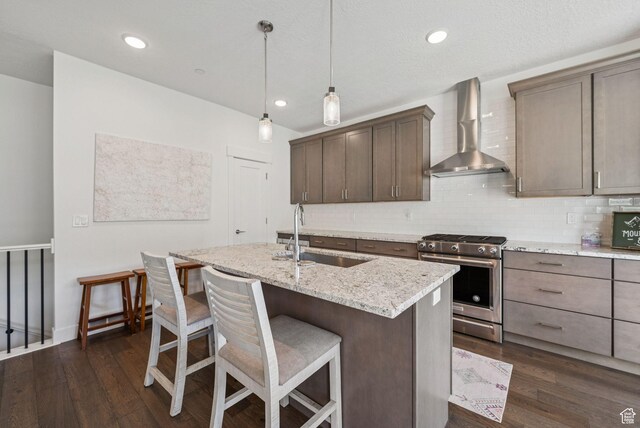 8210 N Toll Creek Ln, Park City, UT 84098 - kitchen with wall chimney exhaust hood, high end stainless steel range, a sink, dark wood-style flooring, and recessed lighting