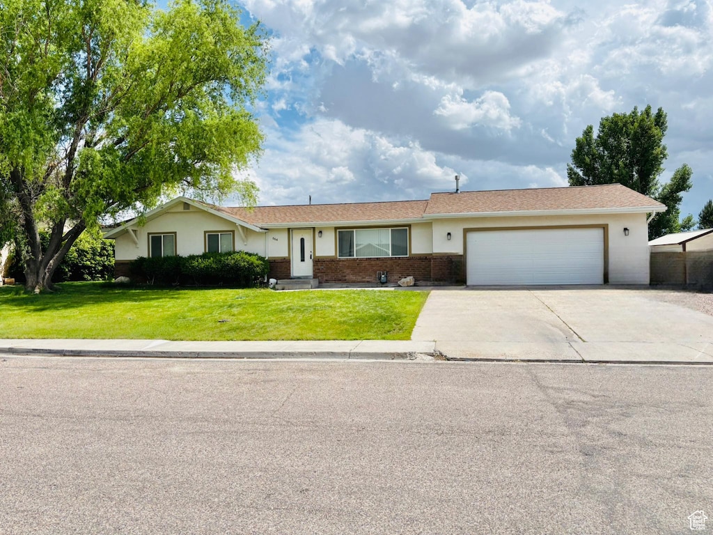 664 E Tamarix St, Delta, UT 84624 - ranch-style home with concrete driveway, a garage, a front yard, and brick siding