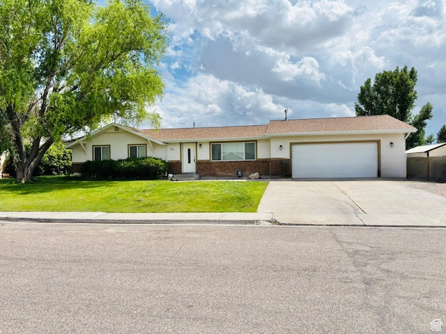 664 E Tamarix St, Delta, UT 84624 - ranch-style home with concrete driveway, a garage, a front yard, and brick siding