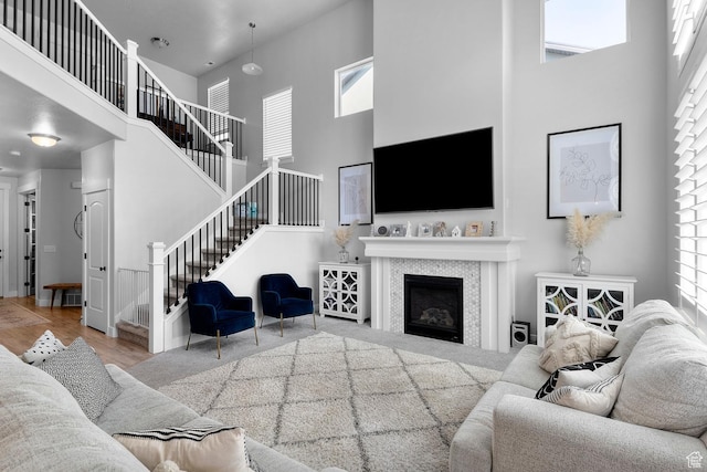 1608 W Gannett Dr, Saratoga Springs, UT 84045 - living area featuring a high ceiling, healthy amount of natural light, stairway, and a fireplace