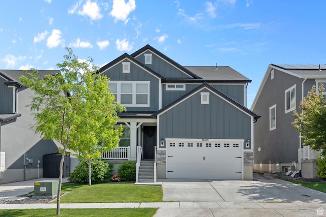 1608 W Gannett Dr, Saratoga Springs, UT 84045 - craftsman house featuring board and batten siding, driveway, a front yard, stone siding, and a porch