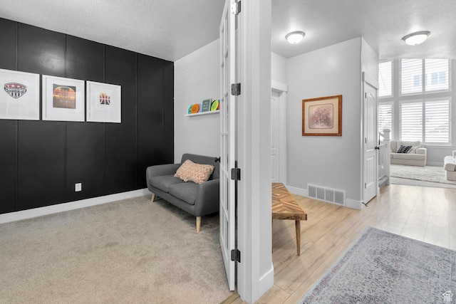 1608 W Gannett Dr, Saratoga Springs, UT 84045 - hall with light wood-style flooring, a textured ceiling, and baseboards