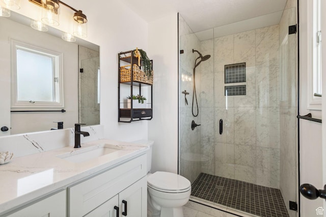 582 S Marialana Way E, North Salt Lake, UT 84054 - bathroom featuring vanity, a stall shower, toilet, and marble finish floors