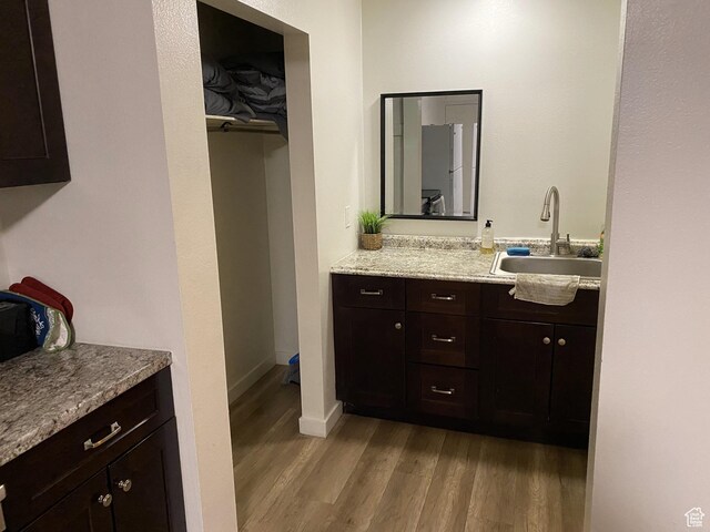 620 W Main St, Green River, UT 84525 - bathroom featuring wood finished floors, vanity, and baseboards