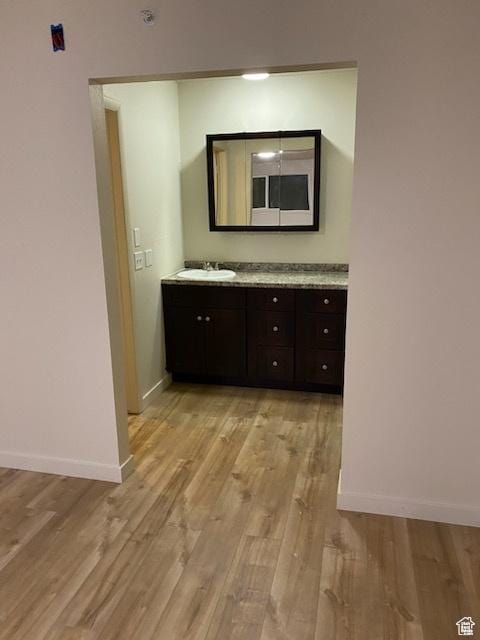620 W Main St, Green River, UT 84525 - hall with light wood finished floors, baseboards, and a sink