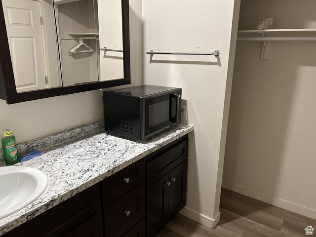 620 W Main St, Green River, UT 84525 - bathroom with wood finished floors, vanity, and baseboards