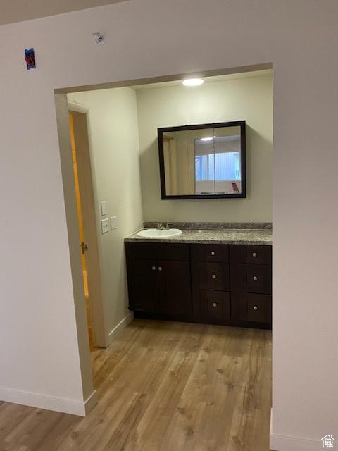 620 W Main St, Green River, UT 84525 - bathroom featuring wood finished floors, vanity, and baseboards