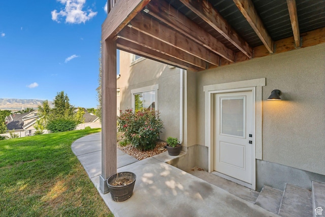 786 S 820 E, Pleasant Grove, UT 84062 - view of exterior entry with stucco siding, a yard, and a patio area
