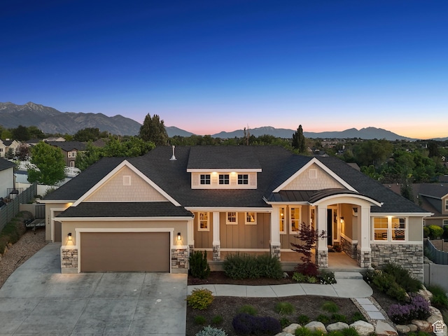 786 S 820 E, Pleasant Grove, UT 84062 - view of front of property with stone siding, an attached garage, a mountain view, driveway, and covered porch