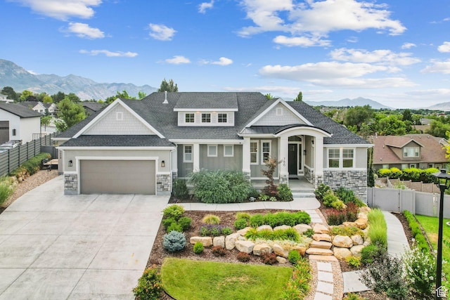786 S 820 E, Pleasant Grove, UT 84062 - view of front of house featuring stone siding, a mountain view, a garage, concrete driveway, and roof with shingles