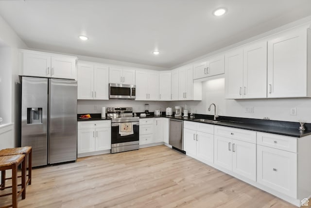 786 S 820 E, Pleasant Grove, UT 84062 - kitchen with appliances with stainless steel finishes, a sink, light wood-style flooring, white cabinets, and recessed lighting
