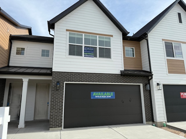 4582 W 3725 S Unit 241, West Haven, UT 84401 - view of front of property featuring a garage, brick siding, and driveway