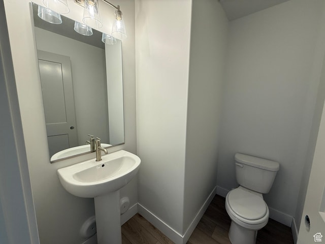 4582 W 3725 S Unit 241, West Haven, UT 84401 - half bathroom featuring toilet, wood finished floors, a sink, and baseboards