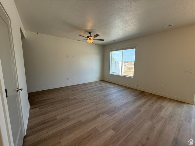 4582 W 3725 S Unit 241, West Haven, UT 84401 - unfurnished room featuring light wood-style floors, a textured ceiling, a ceiling fan, and baseboards