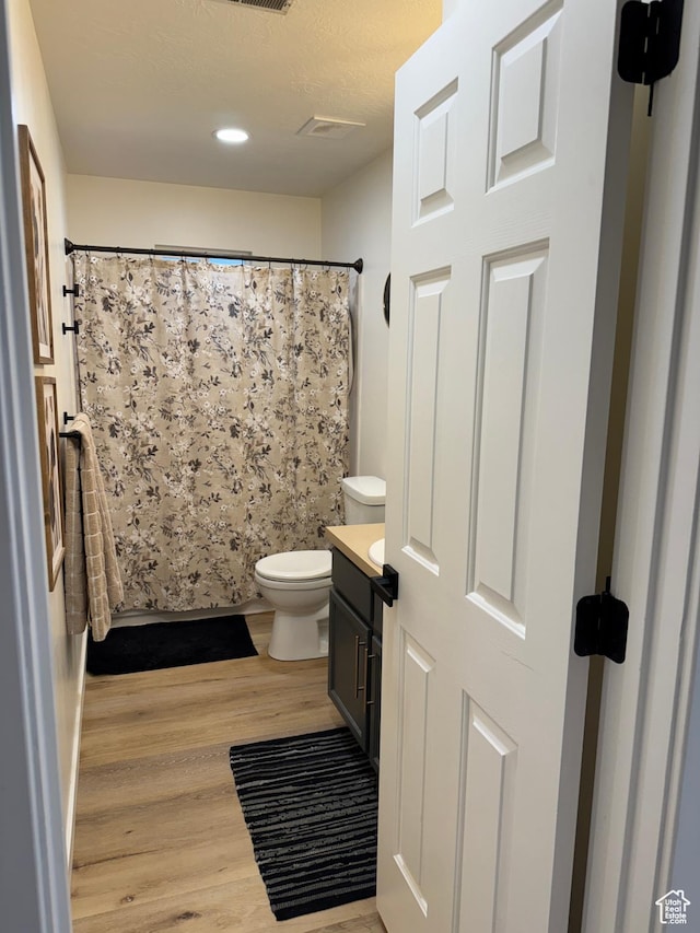 1720 N 2340 W, Lehi, UT 84043 - full bathroom featuring wood finished floors, toilet, vanity, curtained shower, and recessed lighting