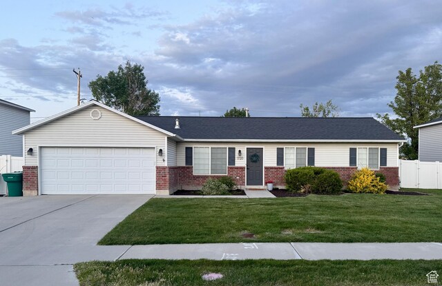 1720 N 2340 W, Lehi, UT 84043 - single story home with brick siding, concrete driveway, and a garage