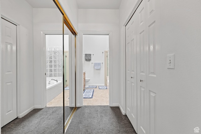 1186 E 900 S Unit 20, St George, UT 84790 - hallway featuring dark colored carpet and baseboards