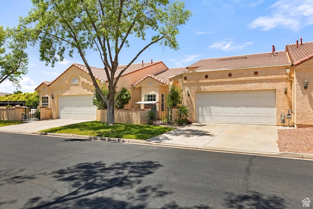 1186 E 900 S Unit 20, St George, UT 84790 - view of front of home featuring concrete driveway, stucco siding, a tile roof, and a garage