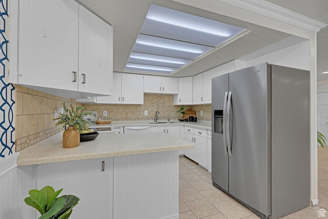 895 E 1015 S, Ogden, UT 84404 - kitchen featuring stainless steel refrigerator with ice dispenser, a sink, a peninsula, white cabinetry, and ornamental molding