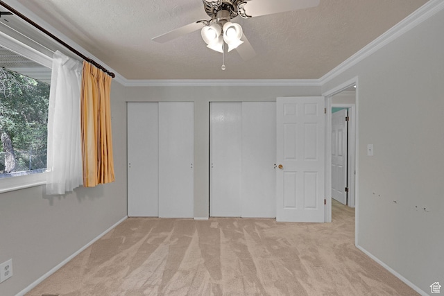 895 E 1015 S, Ogden, UT 84404 - unfurnished bedroom with two closets, carpet floors, ornamental molding, a textured ceiling, and a ceiling fan