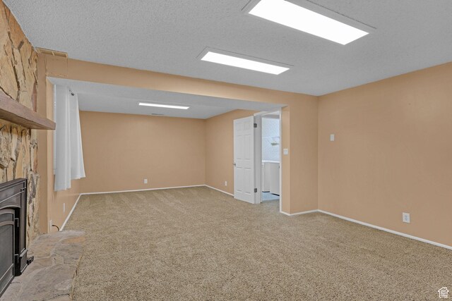 895 E 1015 S, Ogden, UT 84404 - unfurnished living room with light colored carpet, baseboards, and a wood stove