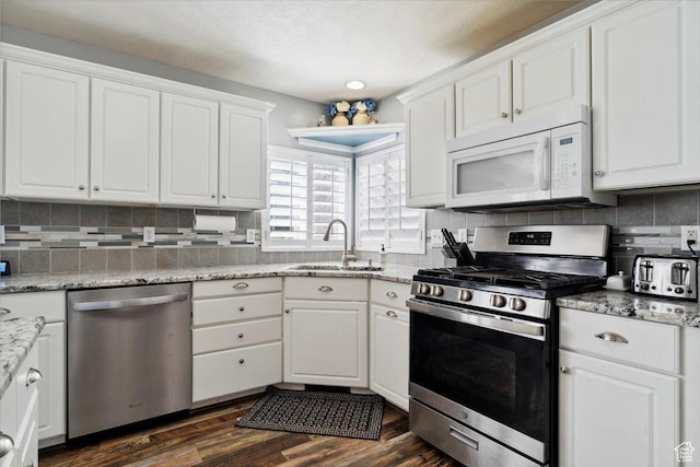 1171 N 900 W, Clinton, UT 84015 - kitchen with stainless steel appliances, a sink, white cabinetry, and dark wood-type flooring
