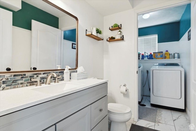 1171 N 900 W, Clinton, UT 84015 - bathroom with separate washer and dryer, toilet, vanity, marble finish flooring, and tasteful backsplash