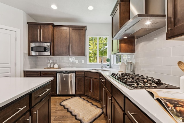 13353 S Wilburton Dr, Draper, UT 84020 - kitchen with appliances with stainless steel finishes, wall chimney exhaust hood, a sink, light countertops, and recessed lighting