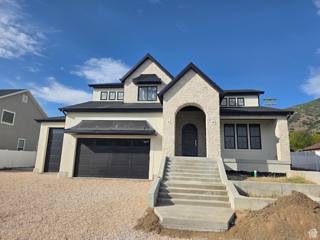 1419 E Heights Way S Unit 15, Fruit Heights, UT 84037 - view of front facade with stone siding, stucco siding, driveway, and an attached garage