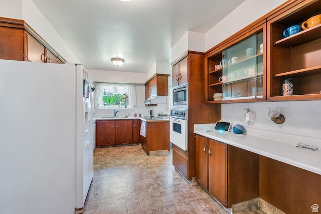 210 N 825 E, American Fork, UT 84003 - kitchen with white appliances, a sink, brown cabinets, open shelves, and light countertops