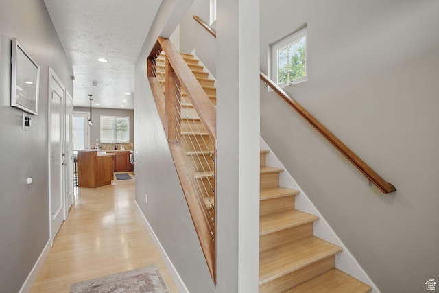 333 E Stanton Ave S, Salt Lake City, UT 84111 - staircase with baseboards, wood finished floors, recessed lighting, and a textured ceiling