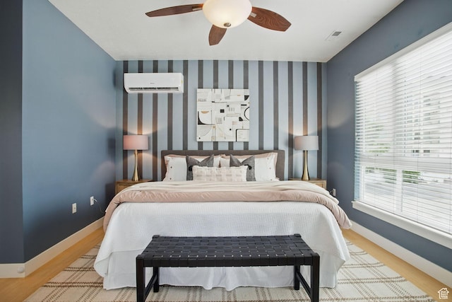 333 E Stanton Ave S, Salt Lake City, UT 84111 - bedroom featuring a wall unit AC, wood finished floors, baseboards, and a ceiling fan