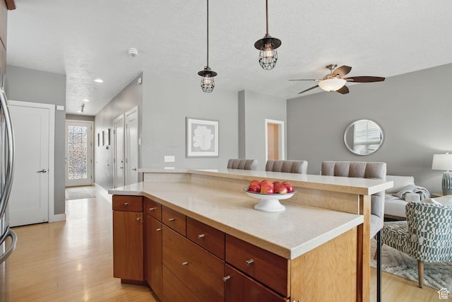 333 E Stanton Ave S, Salt Lake City, UT 84111 - kitchen with light wood-style flooring, open floor plan, light countertops, a ceiling fan, and a center island