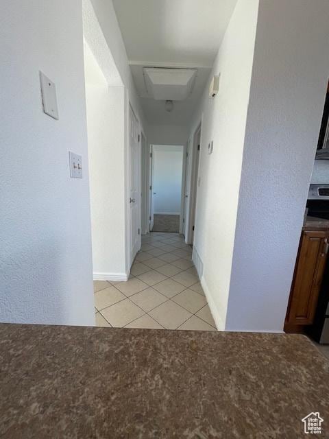 3780 S 7200 W, Magna, UT 84044 - corridor featuring attic access, light tile patterned floors, baseboards, and light colored carpet