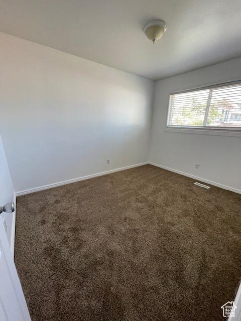 3780 S 7200 W, Magna, UT 84044 - empty room with dark carpet and baseboards