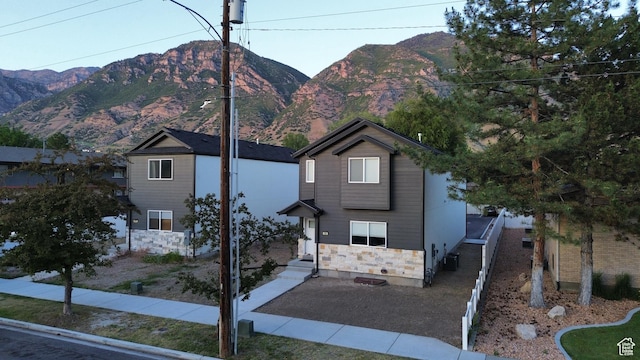 105 S 600 E, Provo, UT 84606 - view of front facade featuring a mountain view, stone siding, and central AC