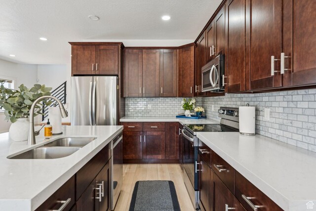 105 S 600 E, Provo, UT 84606 - kitchen featuring appliances with stainless steel finishes, a sink, light countertops, light wood finished floors, and recessed lighting