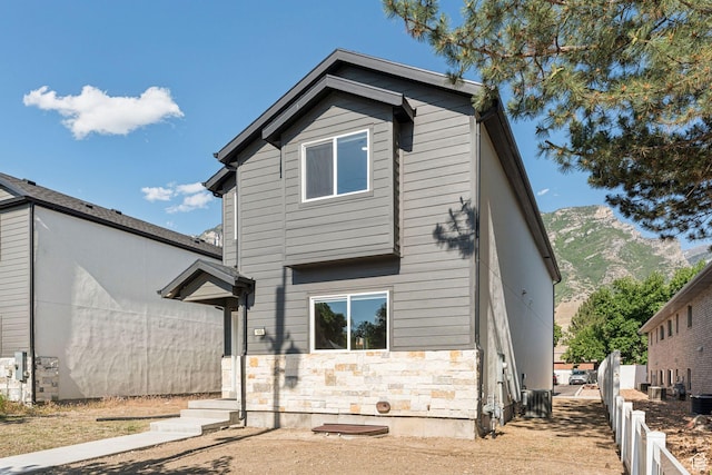 105 S 600 E, Provo, UT 84606 - back of property with stone siding, a mountain view, and central AC
