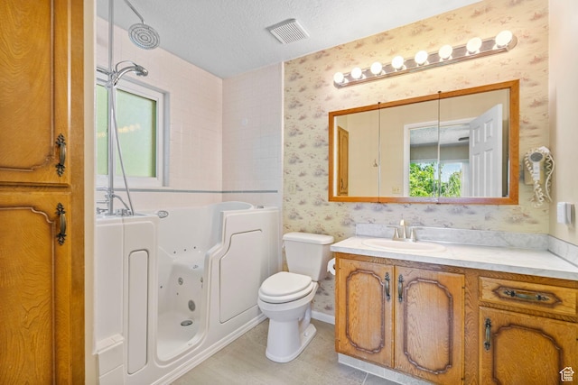 2718 E 200 N, Layton, UT 84040 - bathroom featuring wallpapered walls, a jetted tub, vanity, toilet, and a textured ceiling